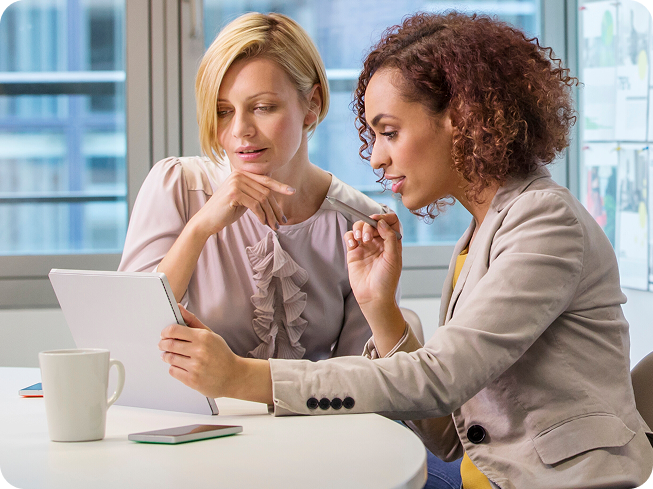 Two women reviewing dental care options together